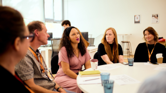 Tara Sabre Collier Tara Sabre Collier speaking to other convening attendees.