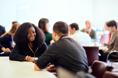 Elizabeth Abubakar chatting to an attendee at the Skoll Community Convening. 