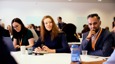 Juliane Reinecke speaking to other conference attendees. 