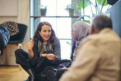 Jessica Jacobson sat on the floor talking to people at the Skoll World Forum.