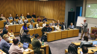 Group of students in a lecture theatre and an animated speaker