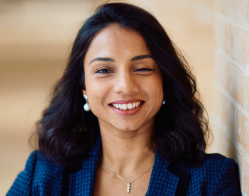 Mahreen Khan Mahreen Khan standing in the Said hallway wearing a blue suit and smiling.
