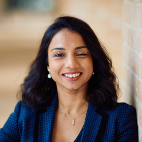 Mahreen Khan Mahreen Khan standing in the Said hallway wearing a blue suit and smiling.