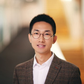 Cheng Li Cheng Li standing in the SBS hallway wearing a brown suit.